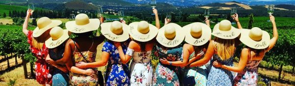 Ladies in hats with raised glasses